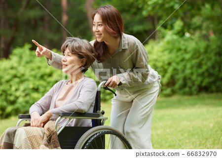 Mother and daughter walking Mother and daughter walking 66832970