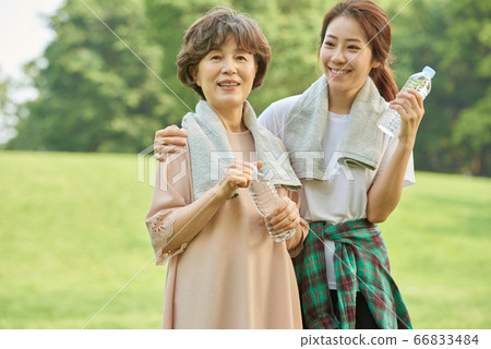 Mother and daughter exercising 66833484