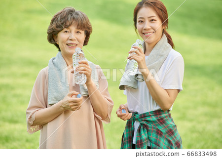 Mother and daughter exercising 66833498