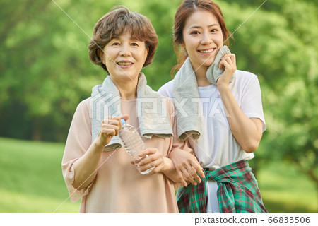 Mother and daughter exercising 66833506
