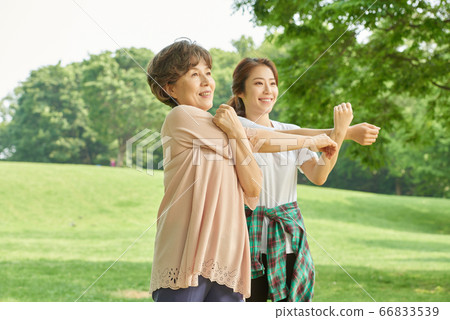 Mother and daughter exercising Mother and daughter exercising 66833539