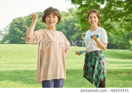 Mother and daughter exercising 66833541