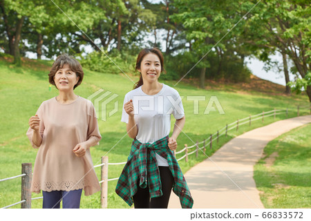 Mother and daughter exercising 66833572