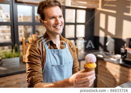 Portrait of an ice cream seller in the shop Portrait of an ice cream seller in the shop 66833726