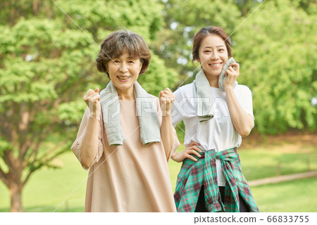 Mother and daughter exercising 66833755