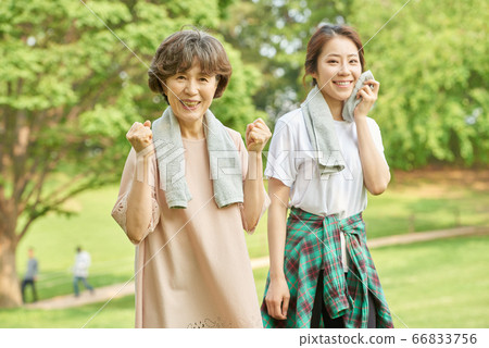 Mother and daughter exercising Mother and daughter exercising 66833756