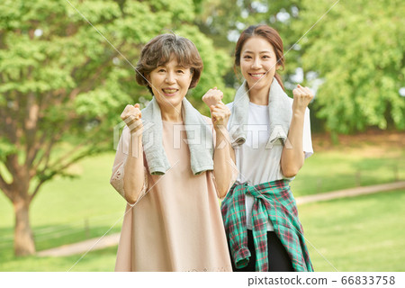Mother and daughter exercising 66833758
