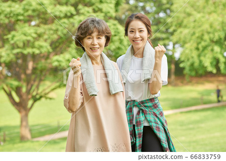 Mother and daughter exercising 66833759