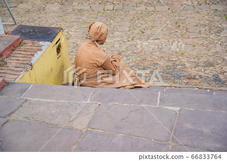 A woman posing in farm-era costumes at Cuba Trinidad Plaza Mayor A woman posing in farm-era costumes at Cuba Trinidad Plaza Mayor 66833764