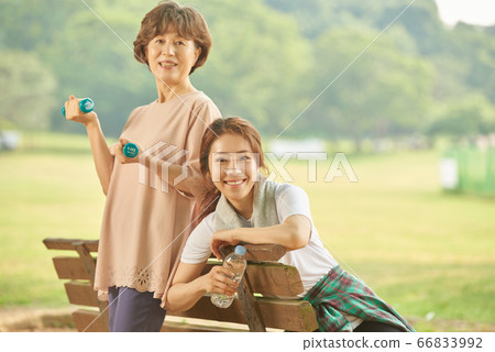 Mother and daughter exercising 66833992