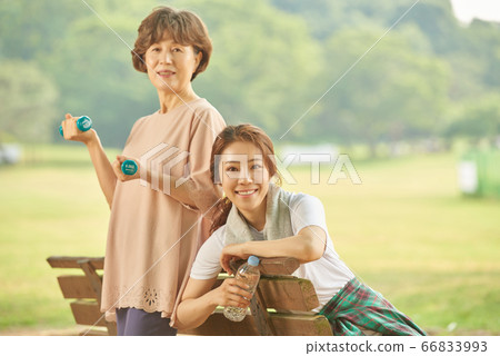Mother and daughter exercising Mother and daughter exercising 66833993