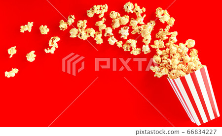 popcorn in classic bucket red and white splashing out of the box popcorn in classic bucket red and white splashing out of the box 66834227