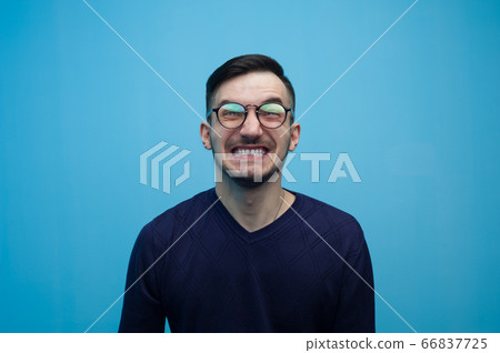 Portrait of an emotional young man in glasses 66837725