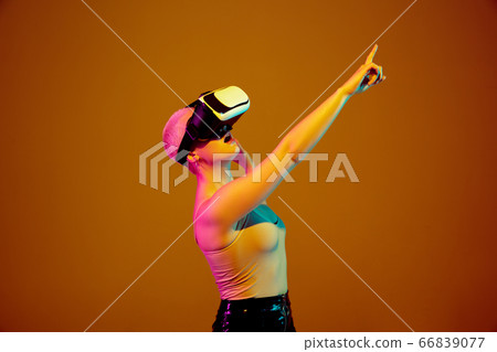 Portrait of young caucasian woman in fashionable eyewear on brown background with copyspace, unusual and freaky appearance 66839077