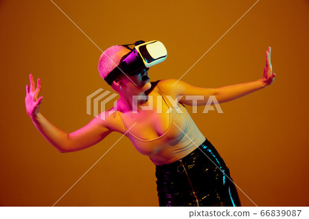 Portrait of young caucasian woman in fashionable eyewear on brown background with copyspace, unusual and freaky appearance Portrait of young caucasian woman in fashionable eyewear on brown background with copyspace, unusual and freaky appearance 66839087