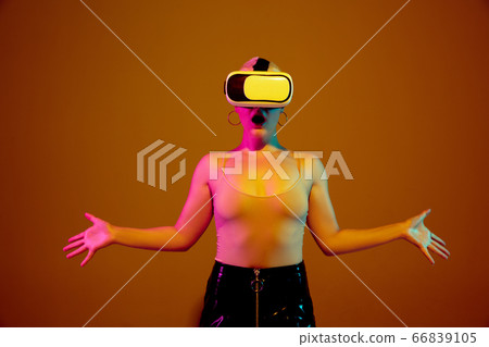 Portrait of young caucasian woman in fashionable eyewear on brown background with copyspace, unusual and freaky appearance Portrait of young caucasian woman in fashionable eyewear on brown background with copyspace, unusual and freaky appearance 66839105