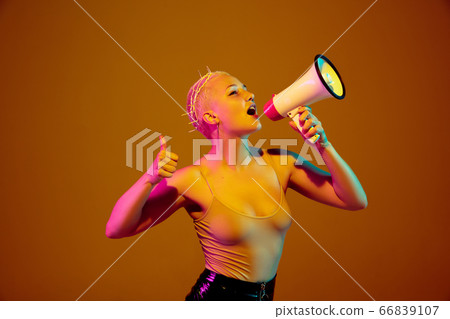 Portrait of young caucasian woman in fashionable eyewear on brown background with copyspace, unusual and freaky appearance Portrait of young caucasian woman in fashionable eyewear on brown background with copyspace, unusual and freaky appearance 66839107