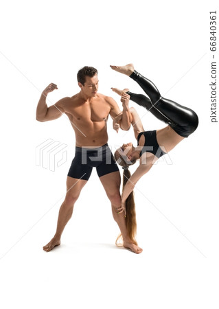Strong man doing acrobatics with beauty girl 66840361