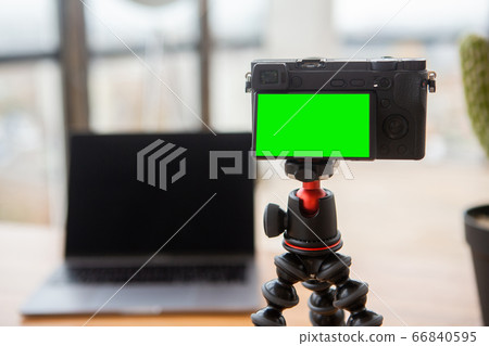 Camera with green screen and laptop behind for video blogging 66840595