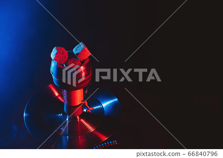 red hot coals of a shisha in a hookah bowl on a black background red hot coals of a shisha in a hookah bowl on a black background 66840796