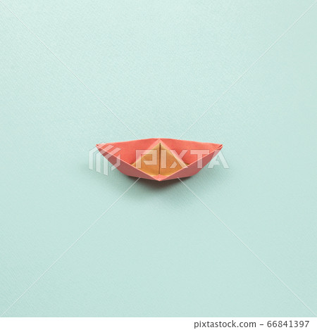 Pink paper ship on blue background. top view Pink paper ship on blue background. top view 66841397