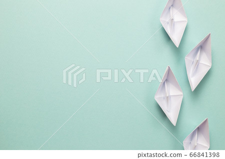 White paper ships on blue background. ships heading for the same destination. Business, success, competition, goal concept White paper ships on blue background. ships heading for the same destination. Business, success, competition, goal concept 66841398