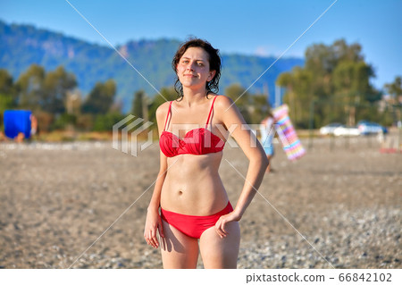 Woman sunbathes at sea tourist resort in summer. 66842102