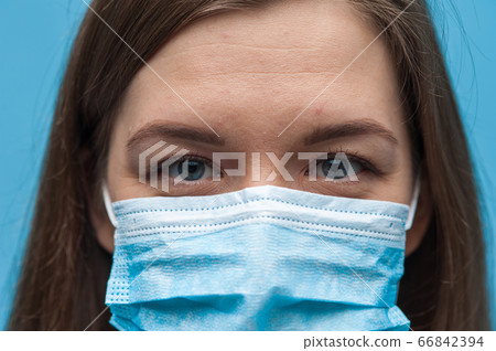 Woman wearing an anti virus protection mask to prevent corona virus 66842394