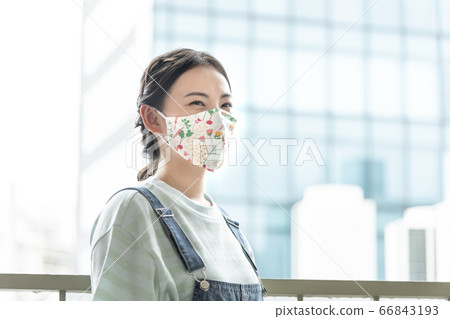 Young woman wearing a floral mask Young woman wearing a floral mask 66843193