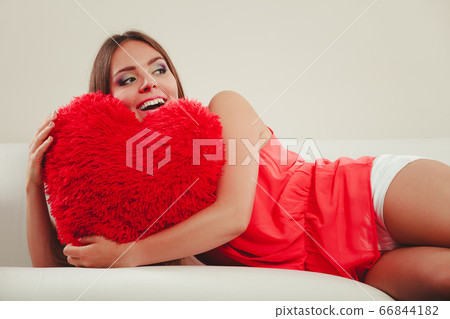 Woman hugging heart shape pillow. Valentines day. Woman hugging heart shape pillow. Valentines day. 66844182