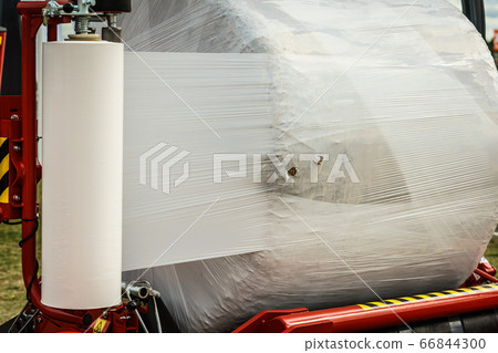 Bale of hay wrapped in plastic foil Bale of hay wrapped in plastic foil 66844300