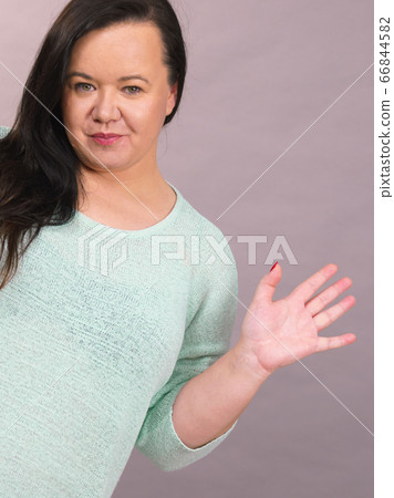 Plus size woman waving Plus size woman waving 66844582