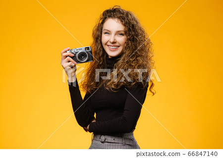 Pretty girl with photocamera and healthy smile Pretty girl with photocamera and healthy smile 66847140