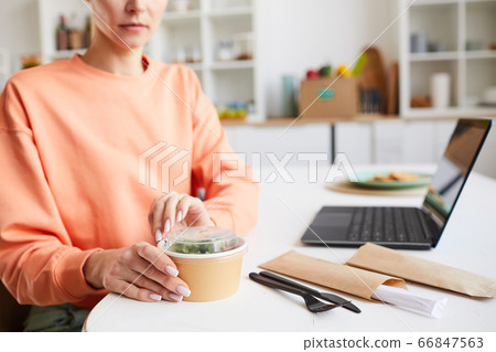 Woman eating takeaway food 66847563