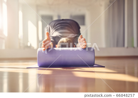 Young man doing exercise with muscle therapy foam roller Young man doing exercise with muscle therapy foam roller 66848257