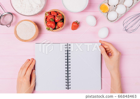 Female hands leafing through blank notebook 66848463