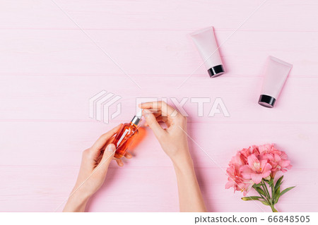 Woman's hands holding cosmetic serum 66848505