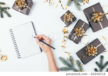 Christmas flat lay composition female hand writes Christmas flat lay composition female hand writes 66848518