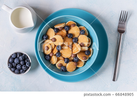Trendy breakfast with mini pancakes, blueberries Trendy breakfast with mini pancakes, blueberries 66848905