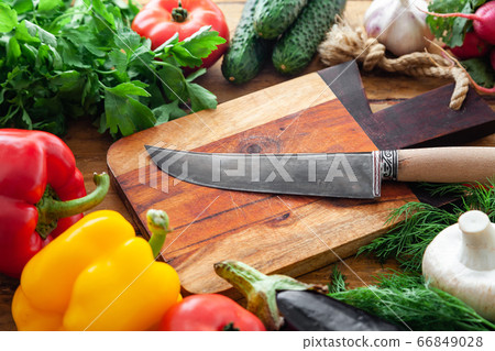 Fresh vegetables and healthy ingredients, knife on cutting board Fresh vegetables and healthy ingredients, knife on cutting board 66849028