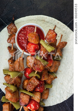 Barbecue pork with vegetables and ketchup on pita Barbecue pork with vegetables and ketchup on pita 66849533