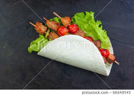 Pork on skewers with vegetables on lettuce and Pork on skewers with vegetables on lettuce and 66849545