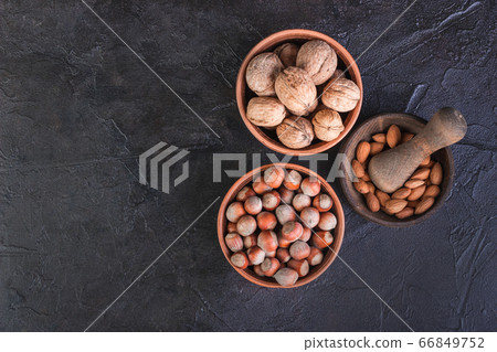 Nuts, walnuts, hazelnuts and mintal on a dark Nuts, walnuts, hazelnuts and mintal on a dark 66849752