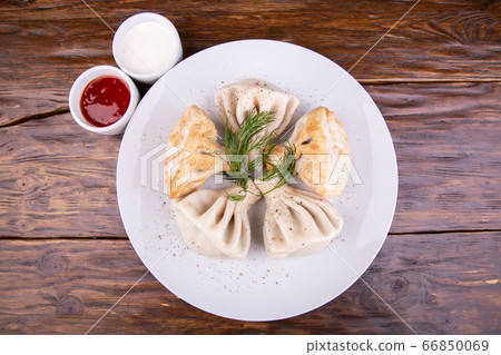 Khinkali boiled and fried with sour cream and ketchup Khinkali boiled and fried with sour cream and ketchup 66850069