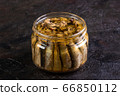 Glass open jar with slots on a concrete background 66850112
