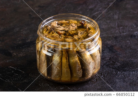 Glass open jar with slots on a concrete background 66850112
