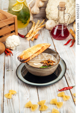 Side view gourmet mushroom cream soup with crouton 66850227