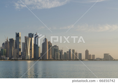 The morning panoramic view of the Doha skyscrapers from the corniche. Doha is a city on the Persian Gulf coast, the capital and largest city in the Arab state of Qatar. 66850742