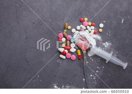 Heroine, syringe and pills on wooden background. Heroine, syringe and pills on wooden background. 66850910