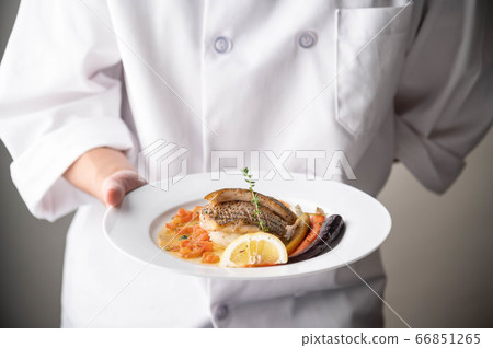 chef serving luxury seabass plate with hand chef serving luxury seabass plate with hand 66851265